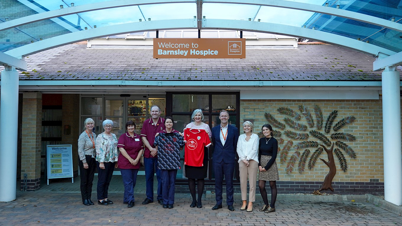 Staff at Barnsley Hospice proudly hold the shirt