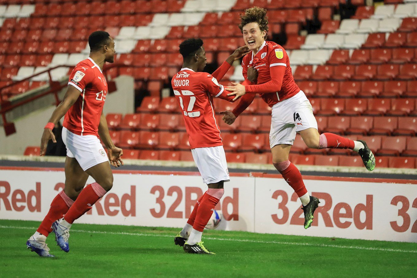 Callum celebrates with Victor Adeboyejo and Clarke Oduor after scoring against Nottingham Forest